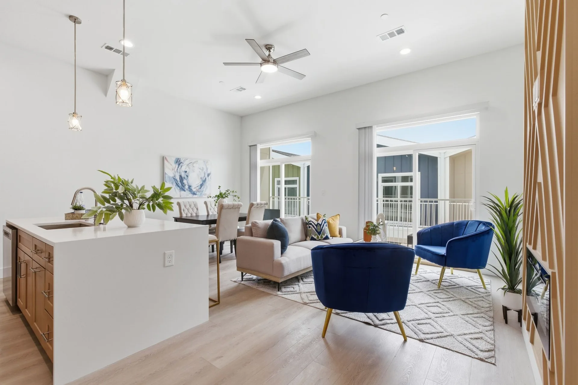 A newly finished living room in navy and oak, with tall windows.